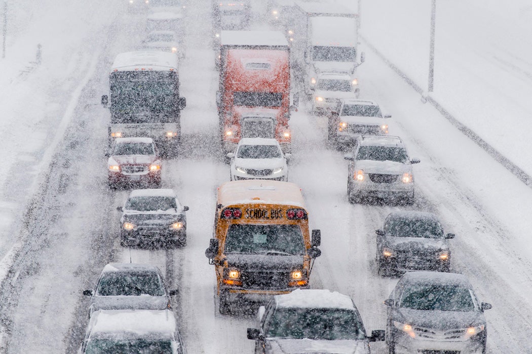 A crowded highway in the midst of snow falling