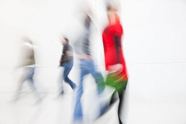 Blurred figures of people walking