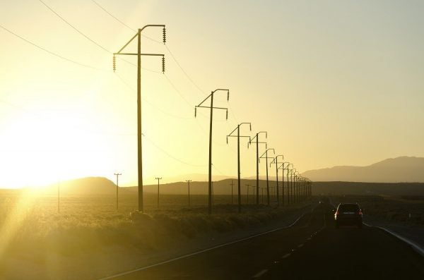 A row of telephone poles alongside a street