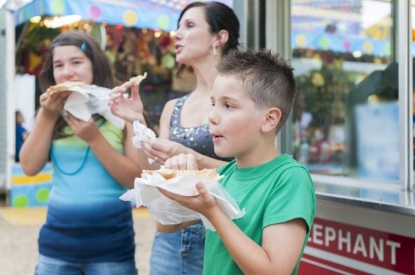 A family eating elephant ears at a fair