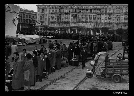 Photo credit: Migrants standing in line to embark CASTEL VERDE at a wharf in Trieste, Italy before departing for Australia, 1953-1954. (Australian National Maritime Museum)