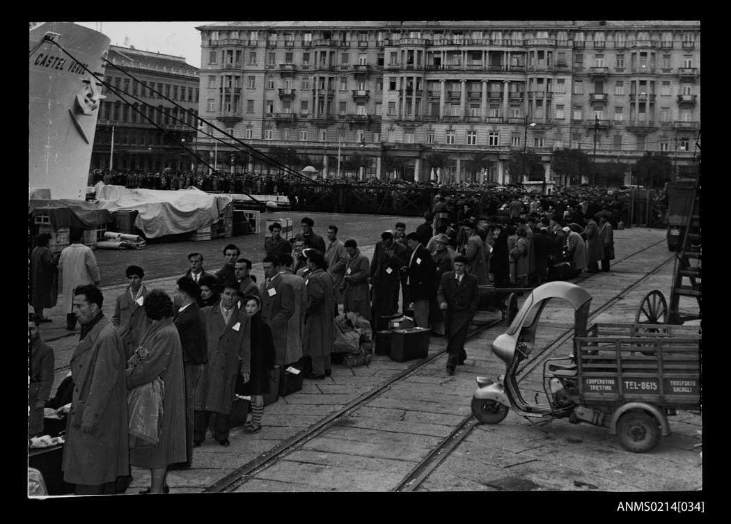 Photo credit: Migrants standing in line to embark CASTEL VERDE at a wharf in Trieste, Italy before departing for Australia, 1953-1954. (Australian National Maritime Museum)