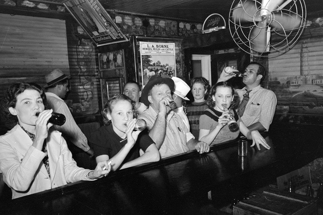 Men and women drinking beer at a pre-prohibition bar in Raceland, Louisiana, September 1938.