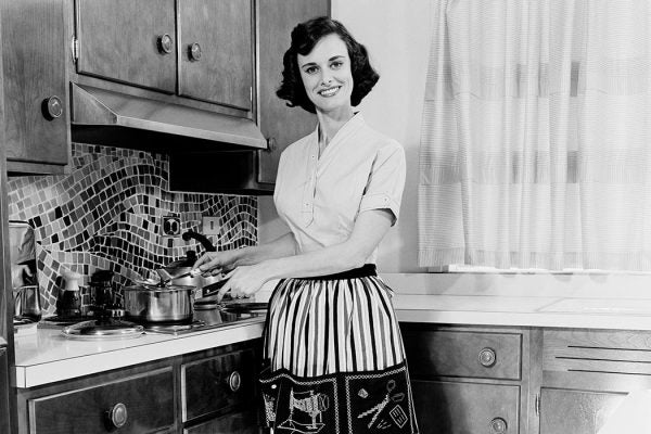 Woman cooking in domestic kitchen.