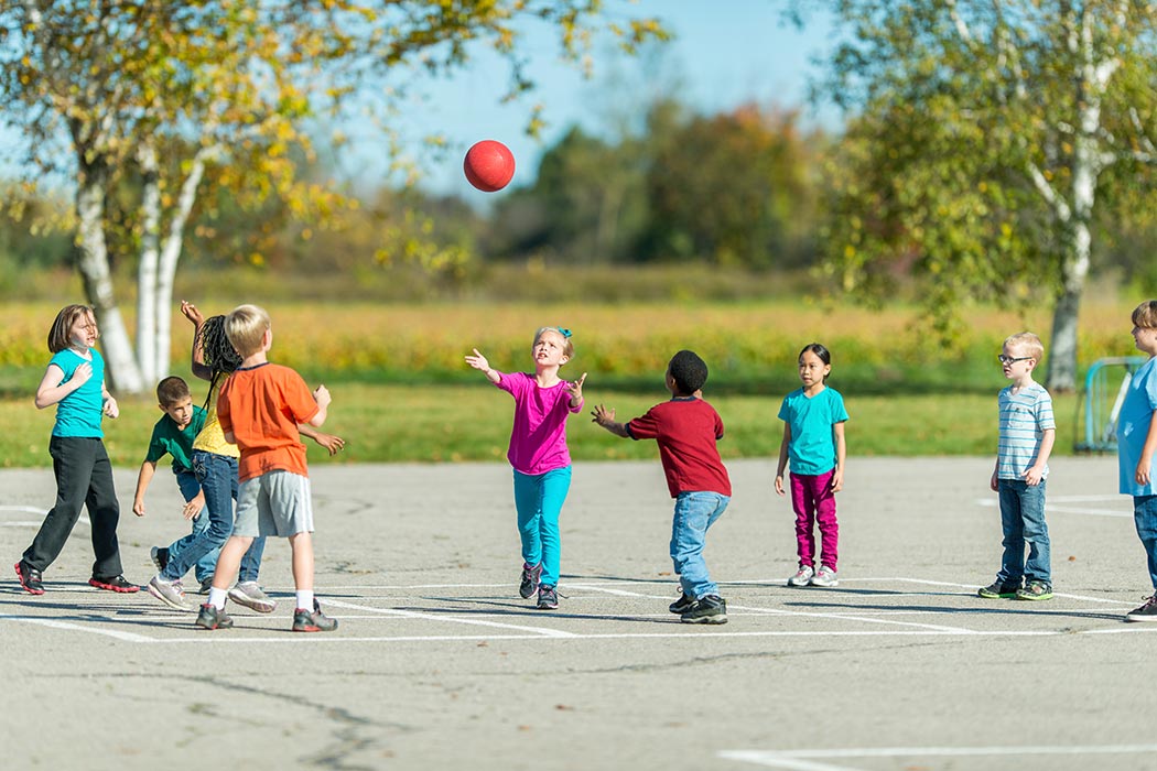 Children playing in the schoolyard during recess.