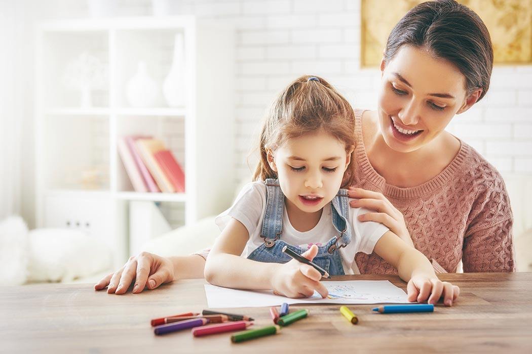 Single mother coloring with her daughter.