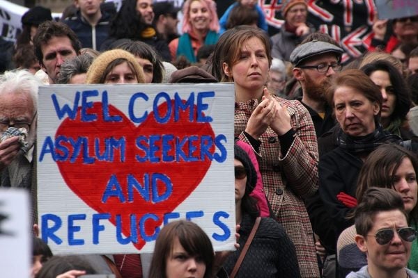 A group assembling to welcome asylum seekers