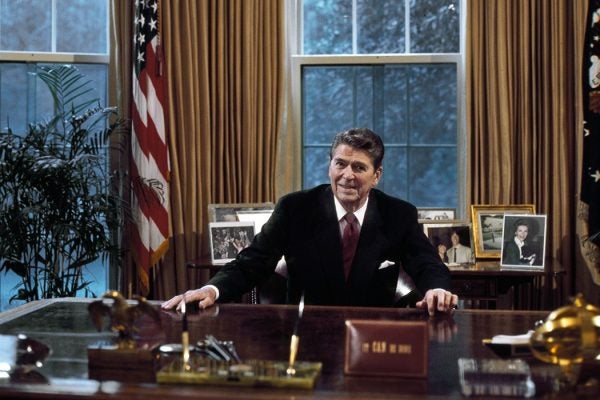 President Ronald Reagan at his desk in the Oval Office.