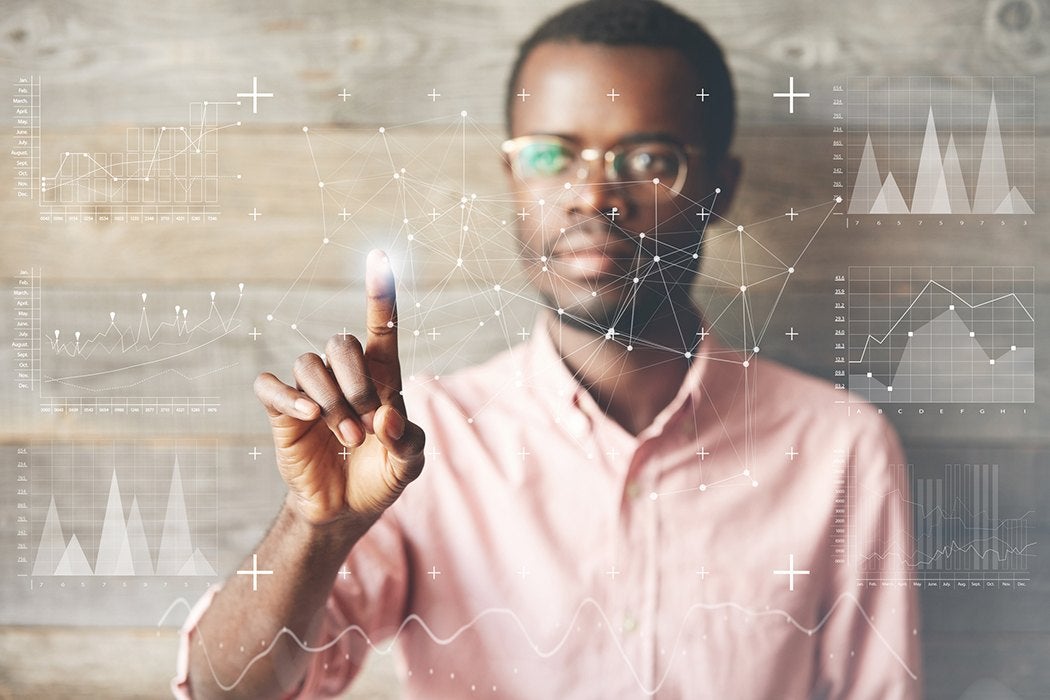 A man uses a futuristic touchscreen interface