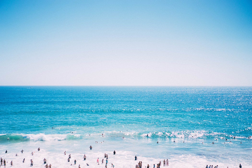 People wading in the water at the beach