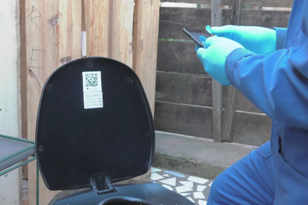 A Loowatt worker replaces the biodegradable waste-collection bag in a waterless toilet in Madagascar