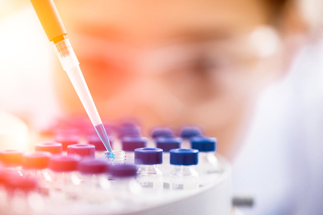 Female chemist at work in laboratory.