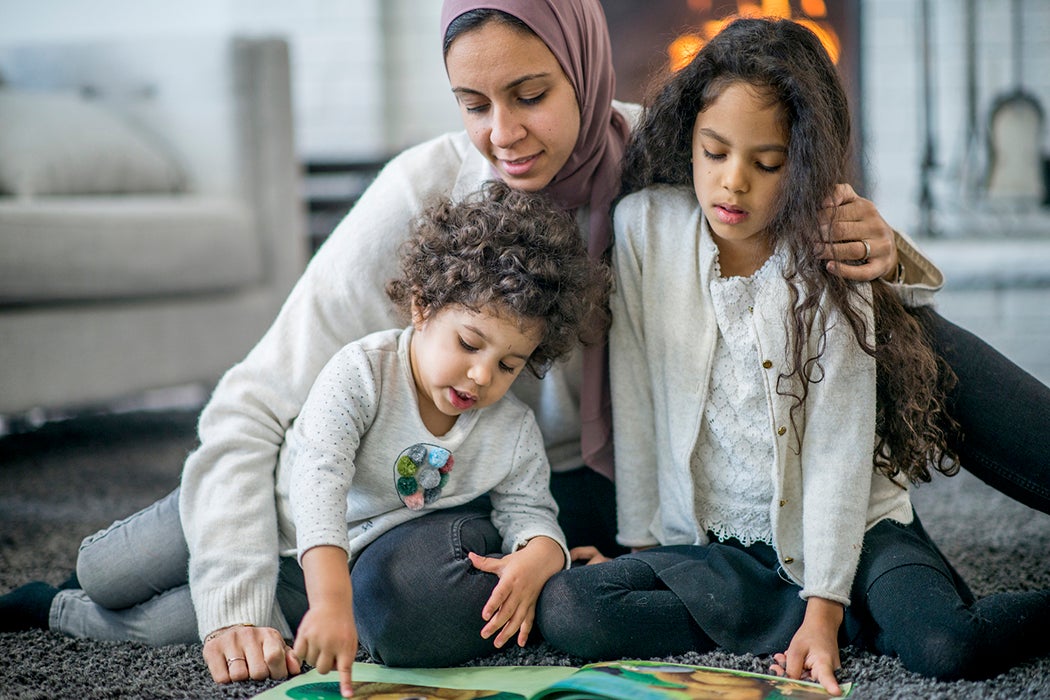 Family reading children's book