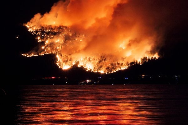 A forest fire reflected in Okanagan Lake, British Columbia, Canada