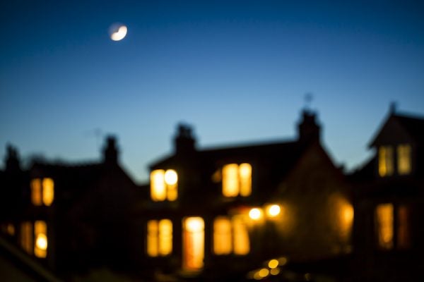 A row of blurry houses lit from within