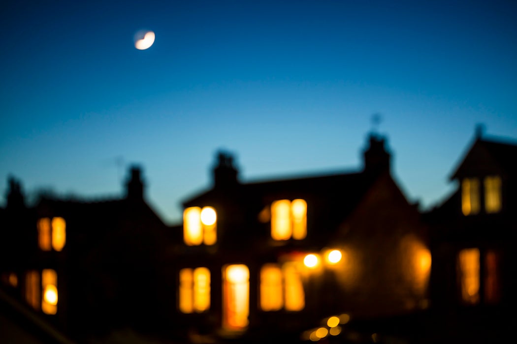 A row of blurry houses lit from within