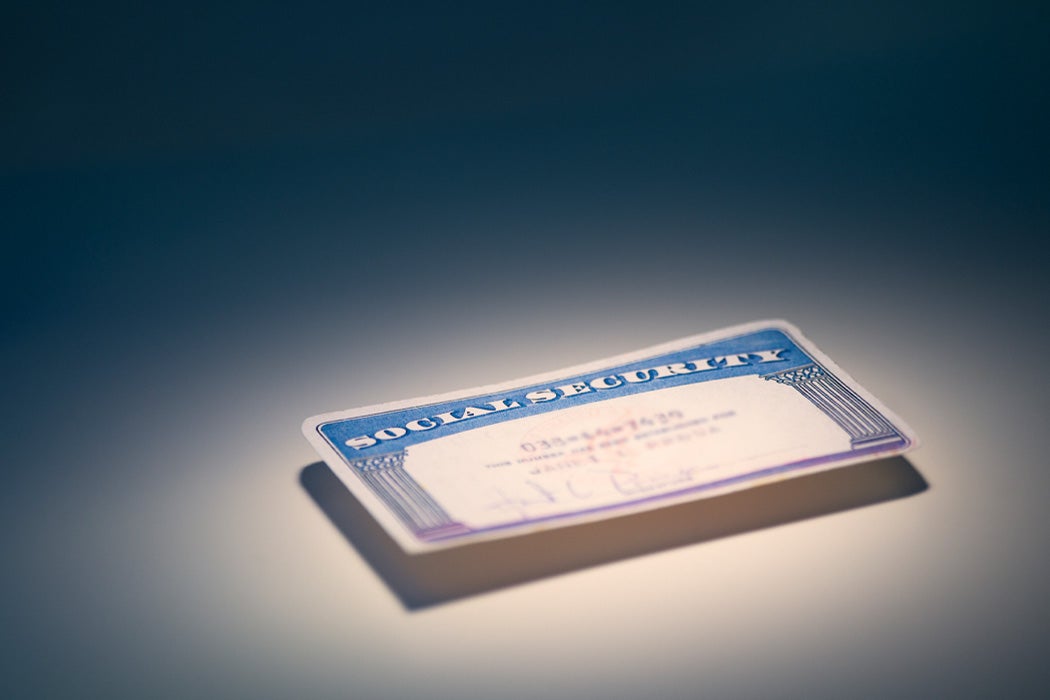 A social security card on a plain surface.