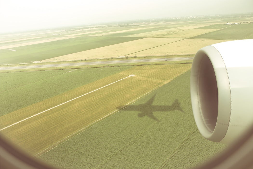 The shadow of an airplane on a field