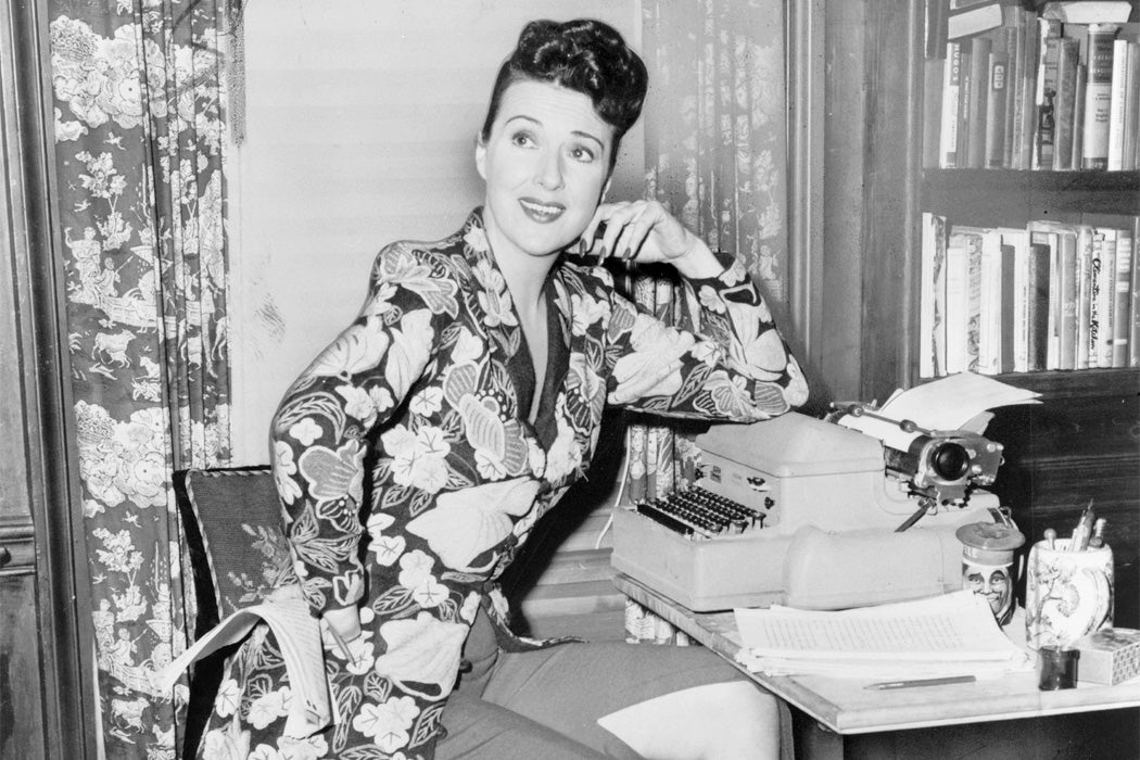 Gypsy Rose Lee seated at a typewriter