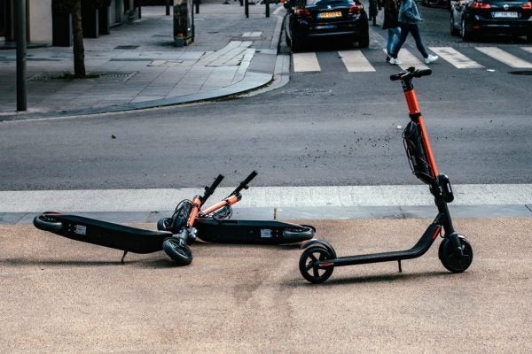 Scooters lying on a sidewalk