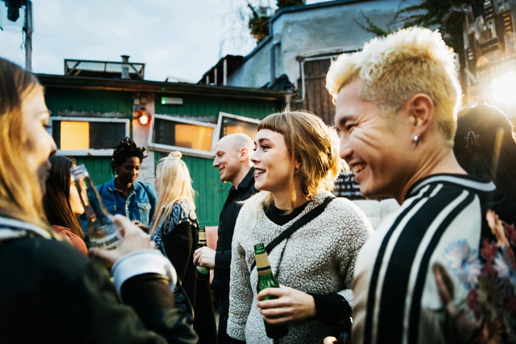 A group of people drinking together outside