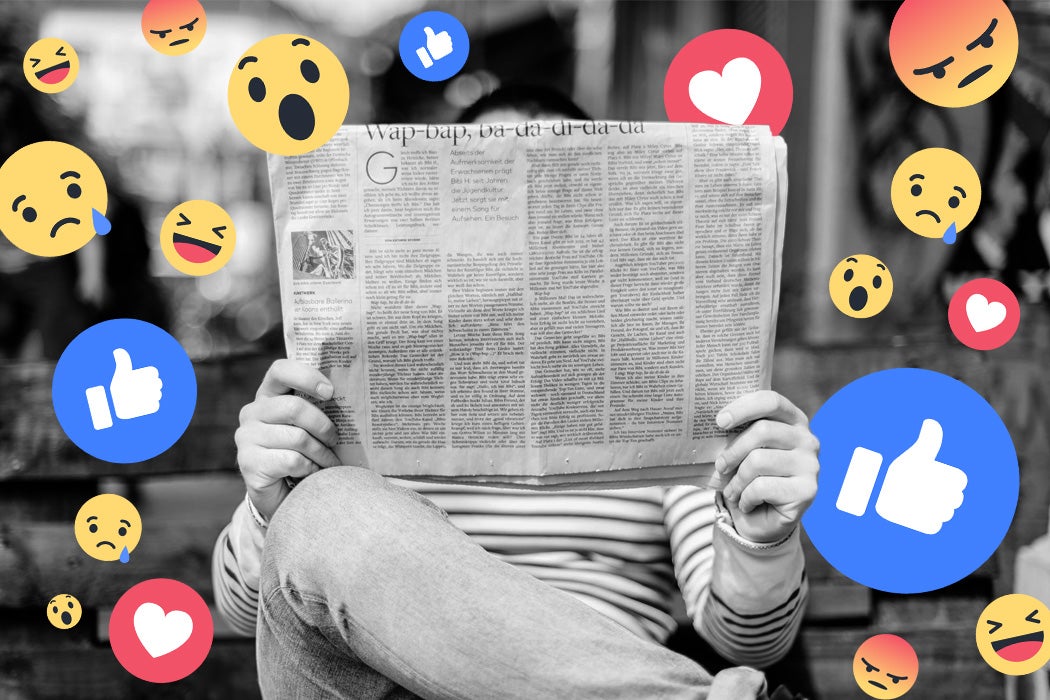 A man reading a newspaper with facebook reactions in a cloud around him