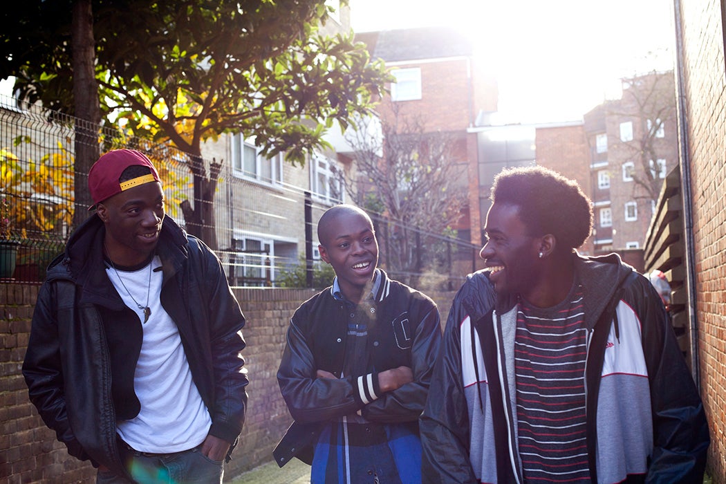 3 boys hanging out outside laughing