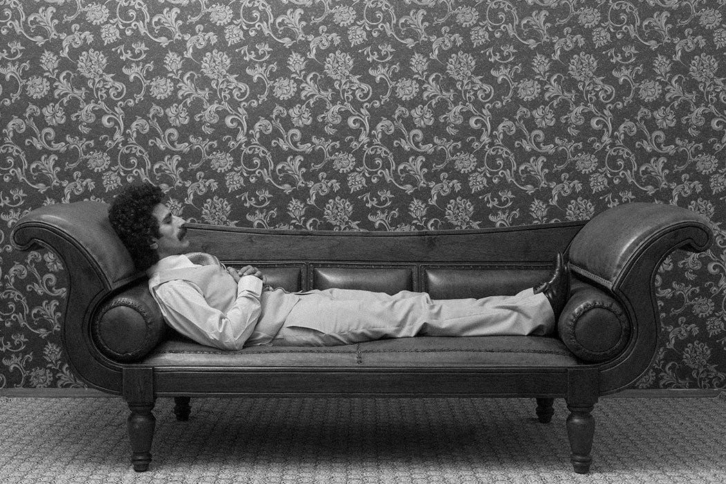 A man lying down on a couch in a psychiatrist office.