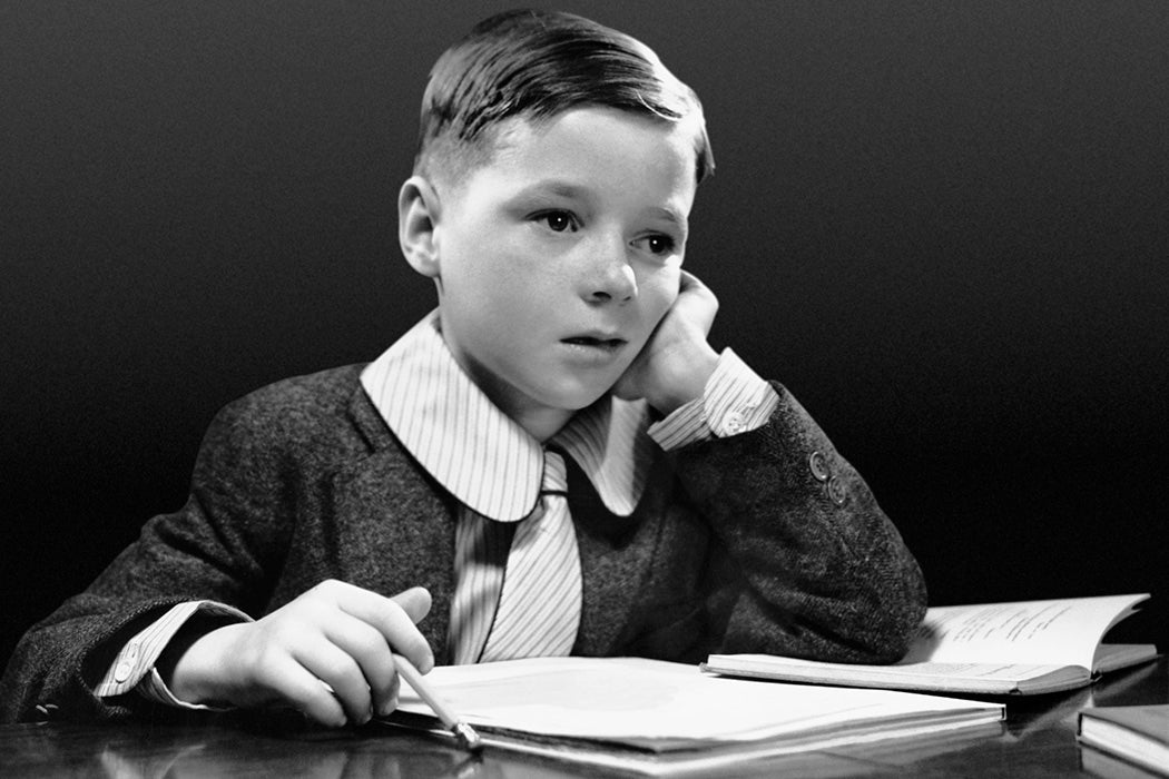 Boy sitting at desk with book