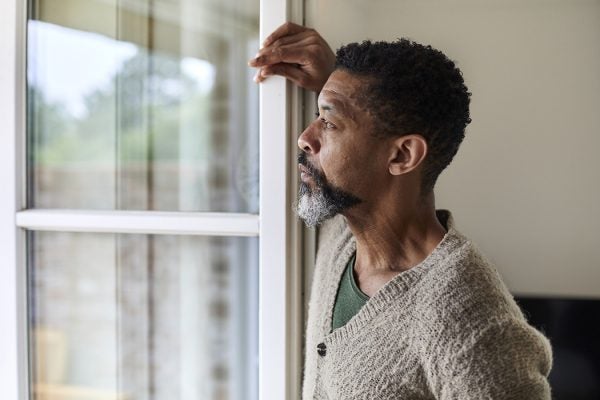 Pensive man looking out of window