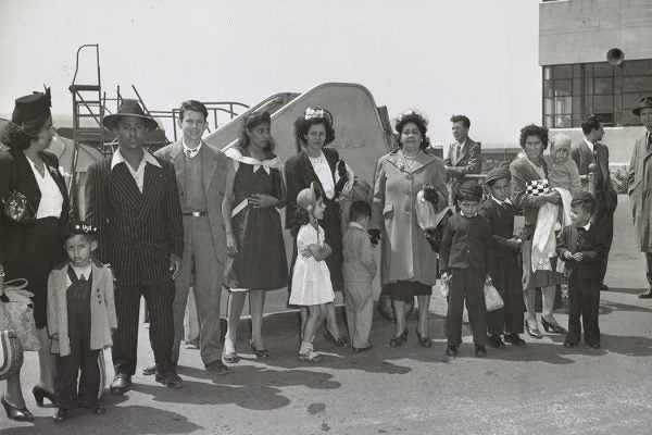 A group of Puerto Ricans at Newark airport, who just arrived by plane from Puerto Rico waiting to be transported to New York, 1947