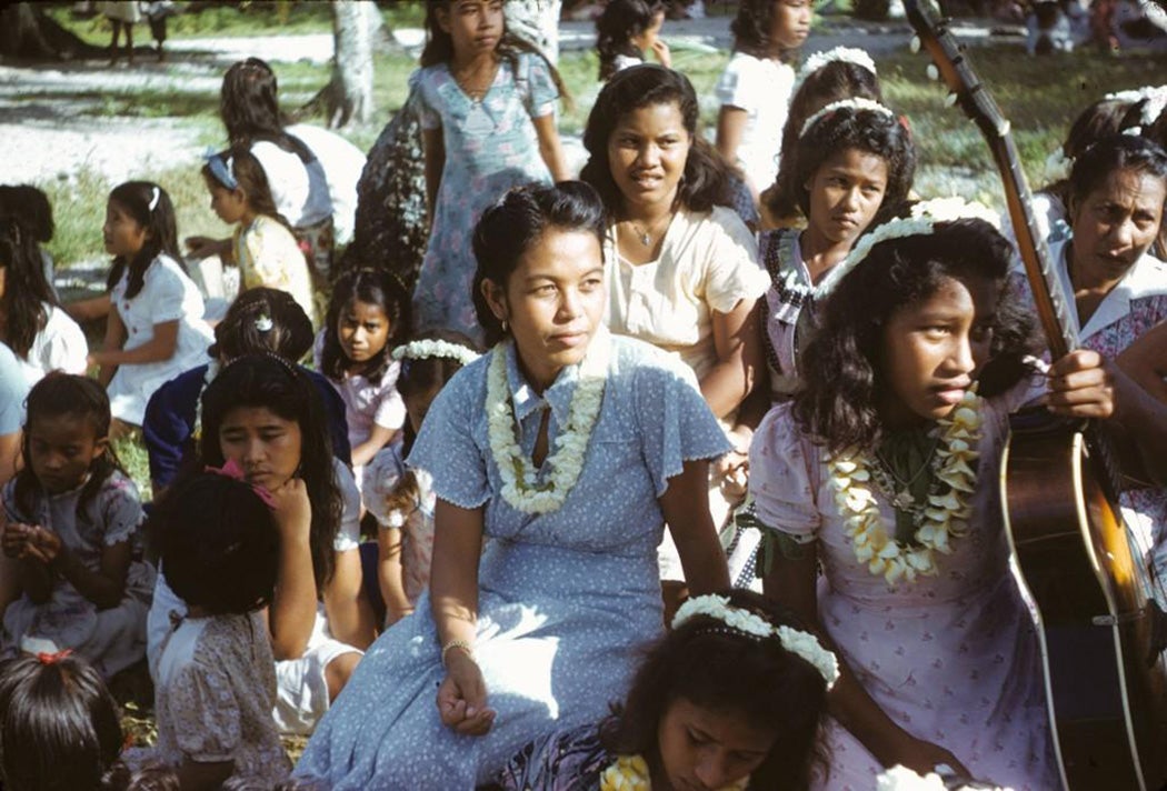 Native women and children with guitar