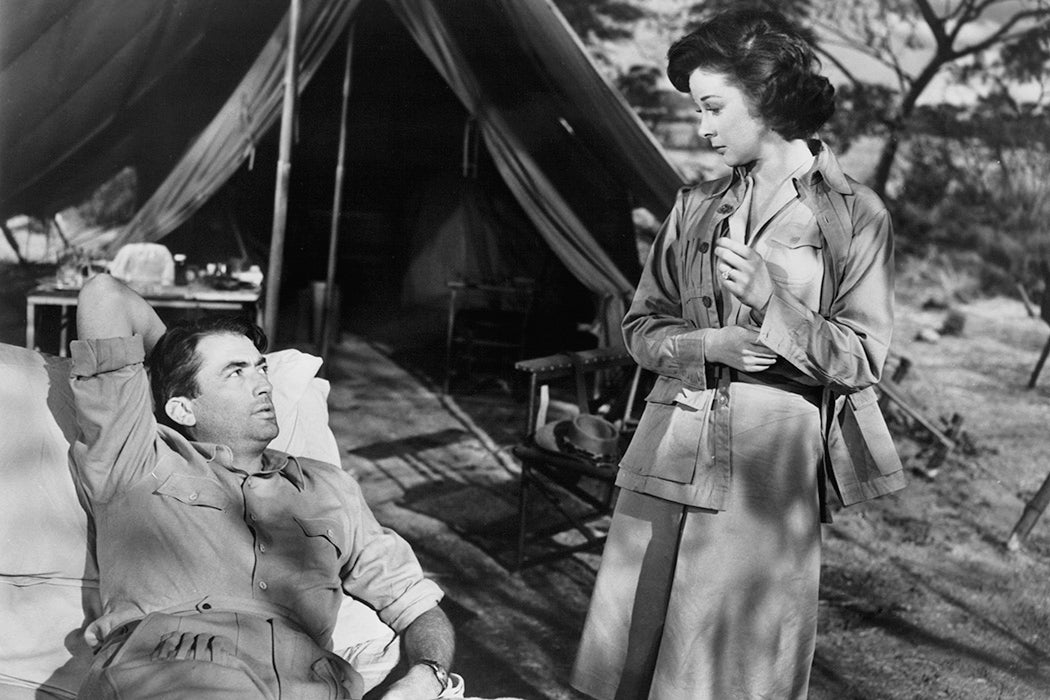 Gregory Peck looking up at Susan Hayward in a scene from the film 'The Snows Of Kilimanjaro', 1952.