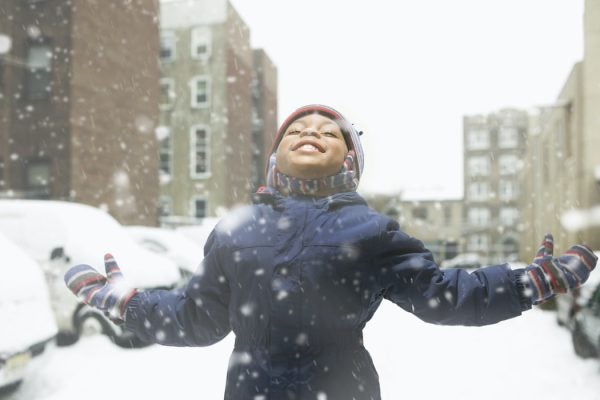 child in snow in the city