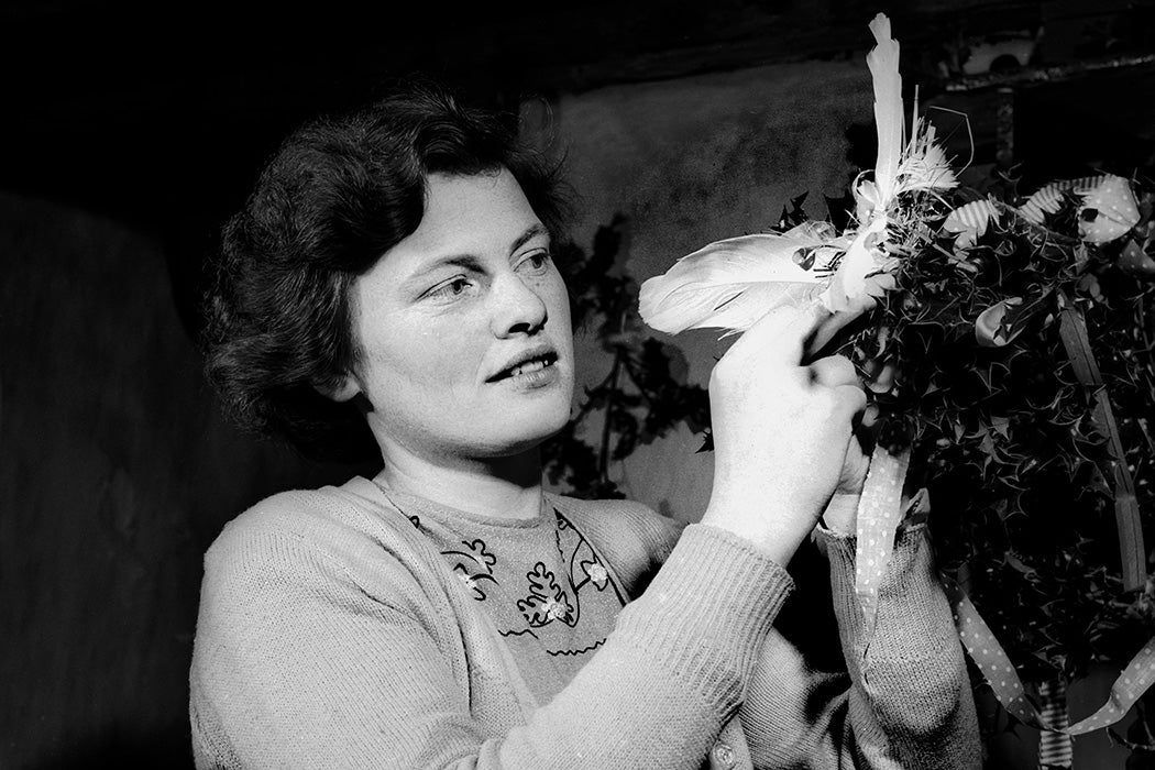 A woman in Ireland makes a 'wren' from ribbons.