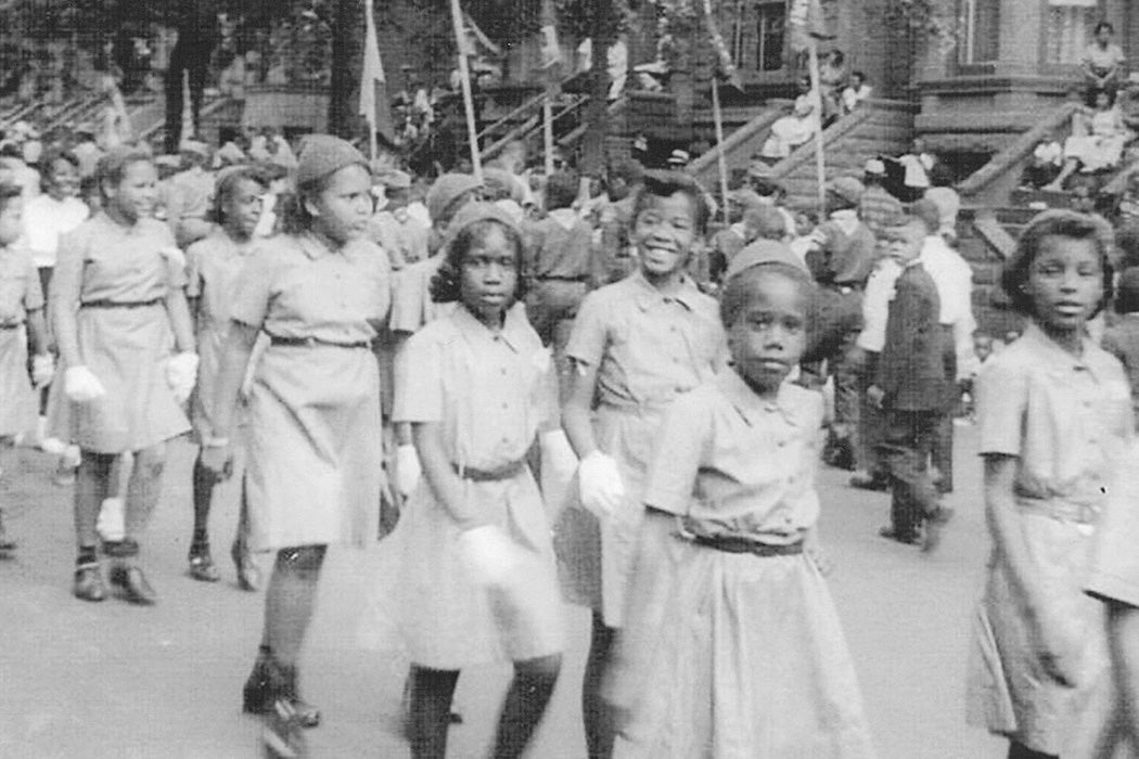 A girl scout troupe marching in parade in Bedford-Stuyvesant, Brooklyn in the 1960s