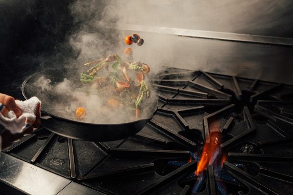 Vegetables cooking in a pan on a stove