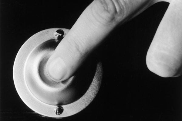 A finger pressing a doorbell, circa 1950.