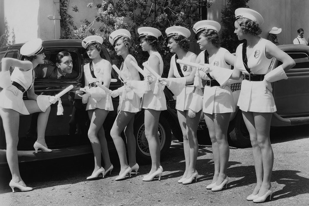 Actor John Boles with extras from his latest musical, 'Redheads On Parade', 1935