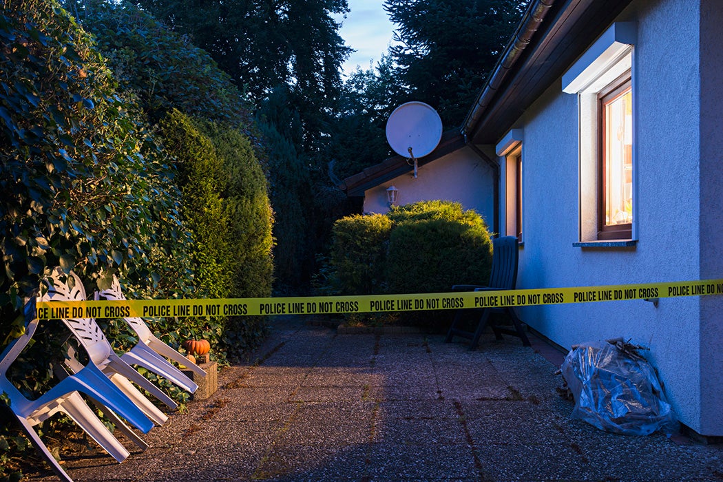 Police tape across a driveway