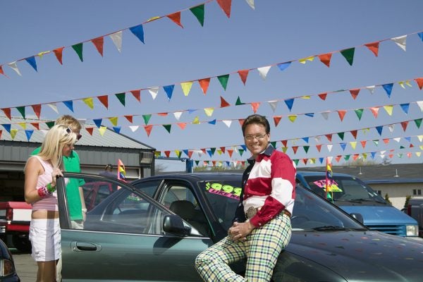 Salesman selling car to couple