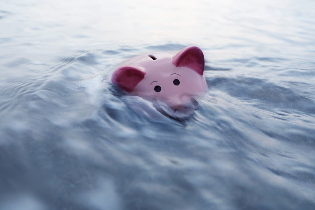 Piggy bank sinking in water