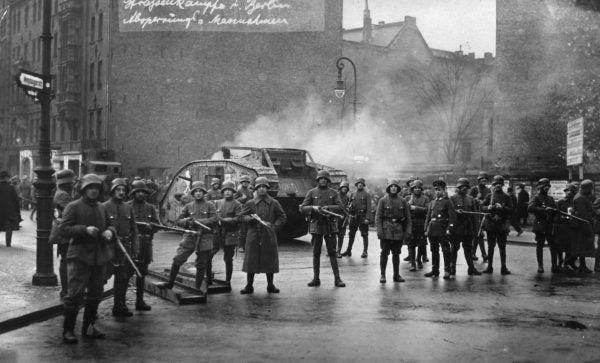 Germain soldiers holding the perimeter around a tank during a time of political unrest during the Weimar Era.