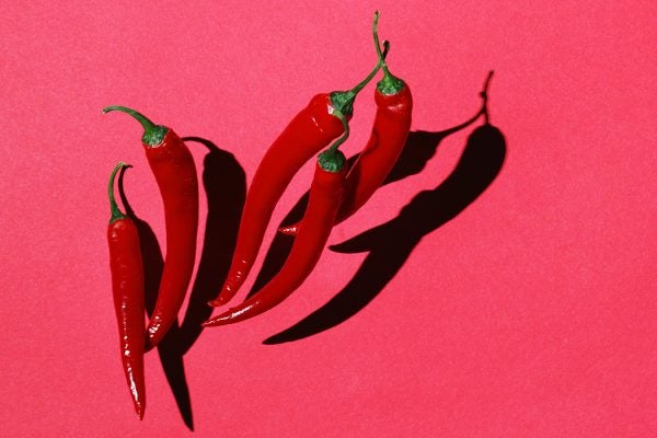 Red chilli peppers photographed on red backdrop