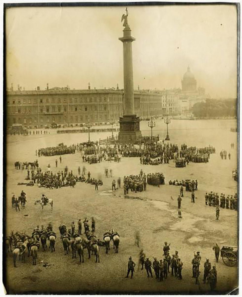 Soldiers and horses gathered in front of the Alexander Column in Palace Square in St. Petersburg