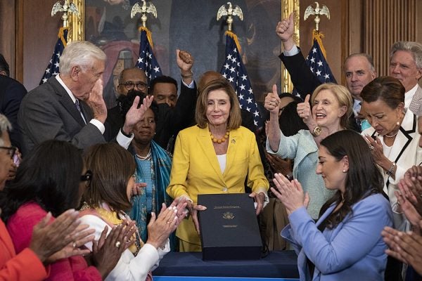 House Democrats applaud after Speaker of the House Nancy Pelosi signed the Inflation Reduction Act, August 12, 2022