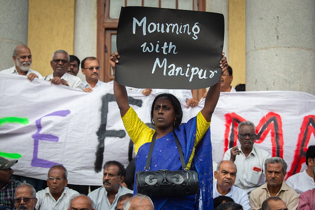 Akkai Padmashali, a prominent transgender activist holds a placard during a protest against violence in the northeastern Indian state of Manipur, on July 21, 2023 in Bengaluru, India.