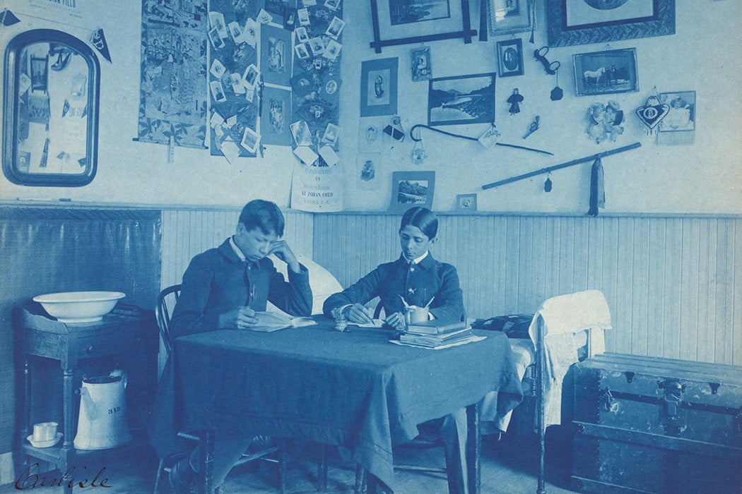 Two boys studying in a dormitory room at Carlisle Indian School, Carlisle, PA, 1901