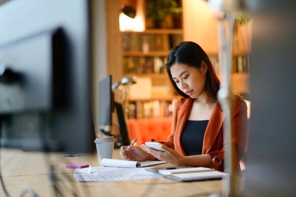 A woman working late at night on business plans